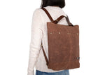 small minimalistic travel backpack with laptop tablet pocket in brown waxed canvas and leather